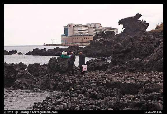 Businessmen on shore near Yongduam Rock, Jeju-si. Jeju Island, South Korea