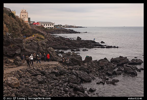 Tourists at Yongduam Rock, Jeju-si. Jeju Island, South Korea (color)