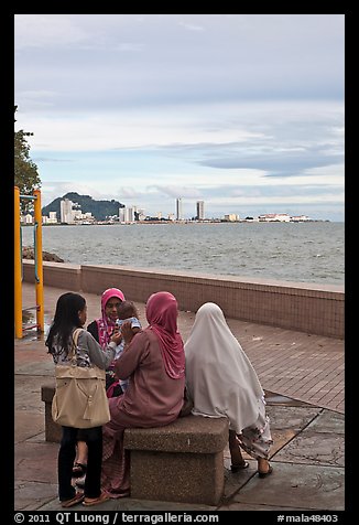 Women on waterfront. George Town, Penang, Malaysia (color)