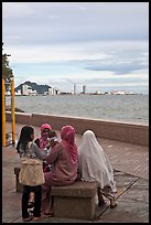 Women on waterfront. George Town, Penang, Malaysia (color)