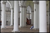 Man in prayer inside Masjid Kapitan Keling mosque. George Town, Penang, Malaysia (color)