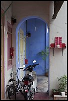 Motorcycle and altar outside townhouse. George Town, Penang, Malaysia ( color)