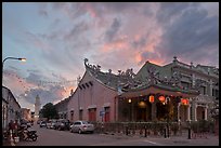 Temple and distant minaret at sunset. George Town, Penang, Malaysia (color)