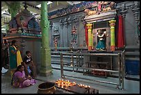 Family in prayer, Sri Mariamman Temple. George Town, Penang, Malaysia