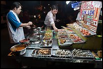 Men arranging skewers on hawker stall. George Town, Penang, Malaysia