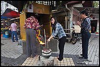 Worshiping at Buddhist street altar. George Town, Penang, Malaysia