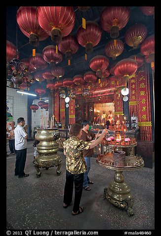 Worshiping inside goddess of Mercy temple. George Town, Penang, Malaysia