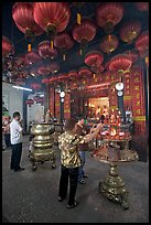 Worshiping inside goddess of Mercy temple. George Town, Penang, Malaysia ( color)