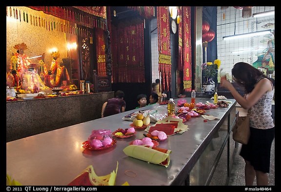 Woman Worshiping inside Chinese temple. George Town, Penang, Malaysia