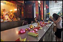 Woman Worshiping inside Chinese temple. George Town, Penang, Malaysia ( color)