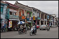 Chinatown street with traffic and storehouses. George Town, Penang, Malaysia