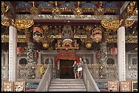 Women standing at Khoo Kongsi entrance. George Town, Penang, Malaysia