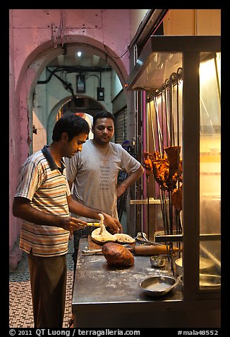 Man preparing nan bread in arcade. George Town, Penang, Malaysia (color)