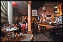 Eating on the street at night. George Town, Penang, Malaysia