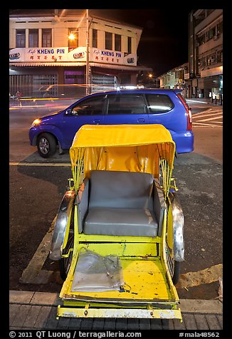 Rickshaw and auto at night. George Town, Penang, Malaysia (color)