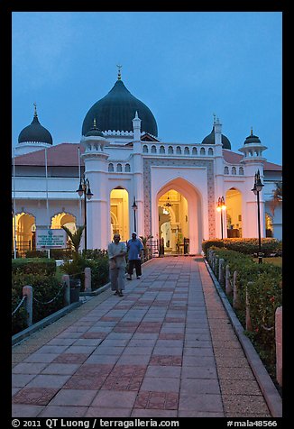 Men walking out of Masjid Kapitan Keling at dawn. George Town, Penang, Malaysia