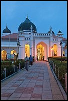 Men walking out of Masjid Kapitan Keling at dawn. George Town, Penang, Malaysia ( color)