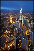 Skyscrappers dominated by Petronas Towers at night. Kuala Lumpur, Malaysia