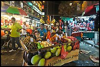 Fruit vendor pushes cart, Jalan Petaling. Kuala Lumpur, Malaysia (color)