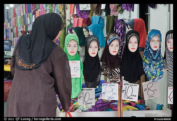 Woman in apparel store with islamic headscarves for sale. Kuala Lumpur, Malaysia (color)