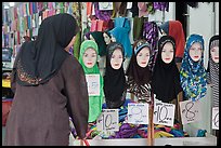 Woman in apparel store with islamic headscarves for sale. Kuala Lumpur, Malaysia (color)