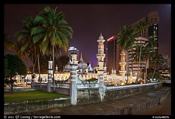 Masjid Jamek mosque and palm tree grove at night. Kuala Lumpur, Malaysia