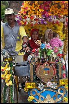 Decorated trishaw driver and passengers. Malacca City, Malaysia ( color)