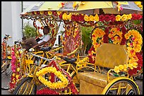 Trishaws decorated with plastic flowers. Malacca City, Malaysia