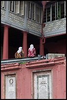 Women sitting, Stadthuys. Malacca City, Malaysia (color)