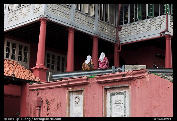 Stadthuys detail with two women. Malacca City, Malaysia (color)