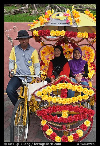 Rider and two women passengers, bicycle rickshaw. Malacca City, Malaysia (color)