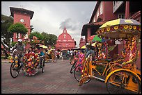 Trishaws, clock tower, and church. Malacca City, Malaysia