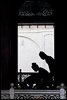 Silhouettes of men bowing in worship, Masjid Kampung Hulu. Malacca City, Malaysia (color)