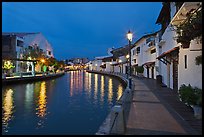 Houses and walkway at dusk, Melaka River. Malacca City, Malaysia