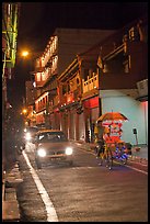 Car and bicycle rickshaw at night. Malacca City, Malaysia