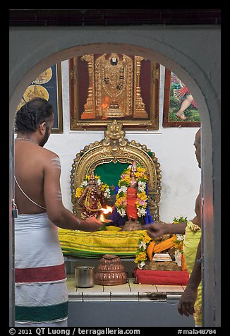 Holy men lighting fire, Sri Poyyatha Vinayagar Moorthi Temple. Malacca City, Malaysia (color)