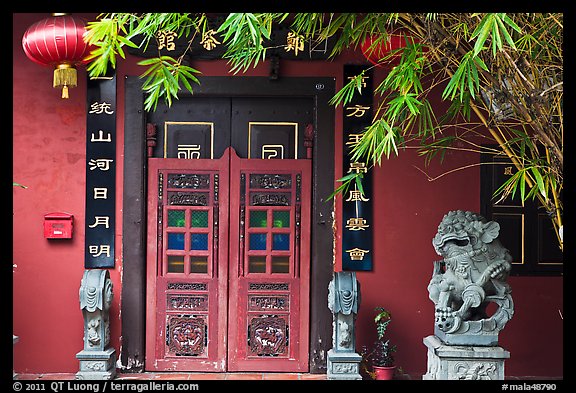 Chinese house entrance with lion sculpture and lanterns. Malacca City, Malaysia