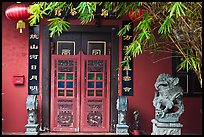 Chinese house entrance with lion sculpture and lanterns. Malacca City, Malaysia