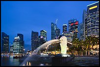 Merlion fountain and skyline at dusk. Singapore