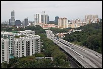 Freeway bordered by parklands and high rises. Singapore