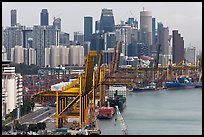 Cranes in harbor and CBD skyscrappers. Singapore