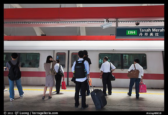 Passengers preparing to board MRT train. Singapore (color)