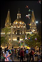 Children play with inflated balloons behind the Cathedral by night. Guadalajara, Jalisco, Mexico ( color)