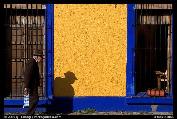 Elderly man walking along a colorful wall, Tlaquepaque. Jalisco, Mexico