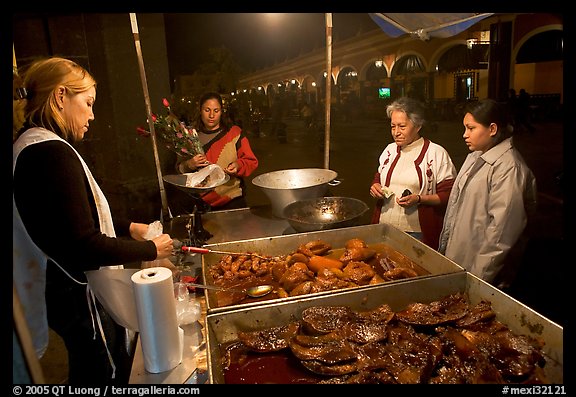 Women buying food at a food stand by night, Tlaquepaque. Jalisco, Mexico