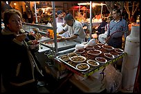 Woman eating by a street food stand , Tlaquepaque. Jalisco, Mexico ( color)