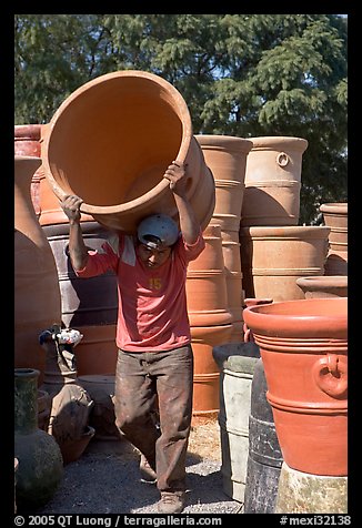 Man carrying a heavy pot, Tonala. Jalisco, Mexico