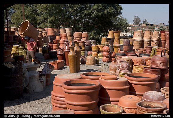 Pots for sale, with a man loading in the background, Tonala. Jalisco, Mexico (color)