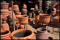 Boy standing next to clay pots, Tonala. Jalisco, Mexico