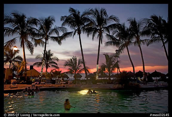 Palm-tree fringed swimming pool at sunset, Nuevo Vallarta, Nayarit. Jalisco, Mexico